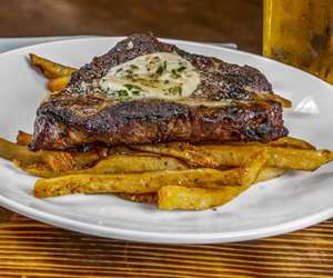 Steak Frites -  Grilled or Au Poivre / Maitre d' Butter / Hand-Cut Truffle Fries or Seasonal Vegetable